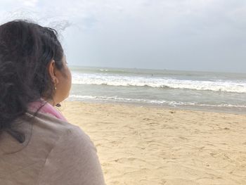 Woman on beach against sky