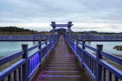 Pier over lake against sky