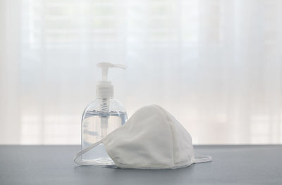 Close-up of bottle on table against window