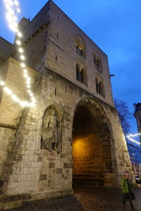 Low angle view of old building against sky at night