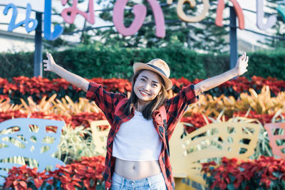 Portrait of smiling young woman standing outdoors