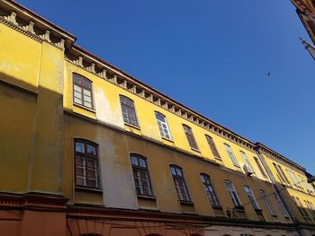 Low angle view of building against clear blue sky