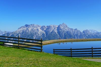 Scenic view of snowcapped mountains against clear blue sky