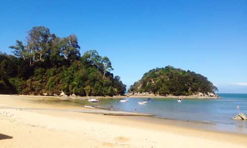 Scenic view of beach against cloudy sky