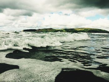 Scenic view of sea against cloudy sky