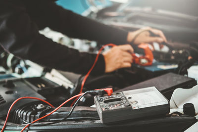 Close-up of man using mobile phone on table