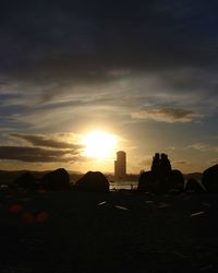 Silhouette buildings against sky during sunset