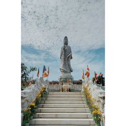 Statue against sky and building