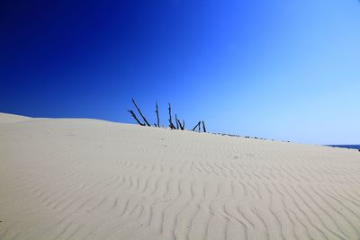 Scenic view of sand dune against clear sky