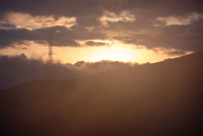 Scenic view of silhouette mountain against sky during sunset