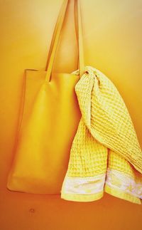 Towel in bag hanging on orange wall