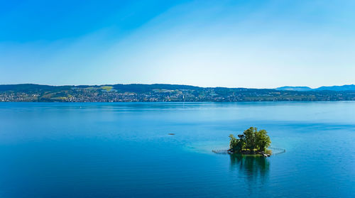 Scenic view of sea against clear blue sky