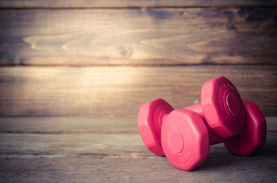 Close-up of pink dumbbells on table