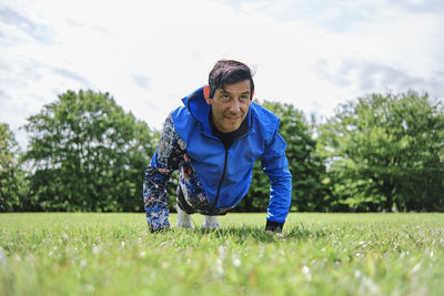 Man doing push-ups while practicing exercise at public park