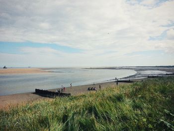 Scenic view of sea against cloudy sky