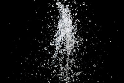 Close-up of water splashing against black background