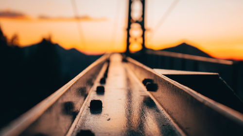 Close-up of railway bridge against sky during sunset