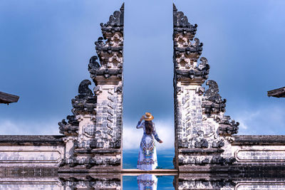 Asian woman standing in bali gate, pura luhur lempuyang temple bali, indonesia