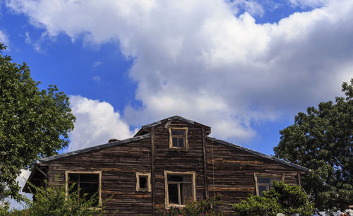 Low angle view of building against cloudy sky