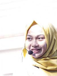 Portrait of young woman talking on microphone