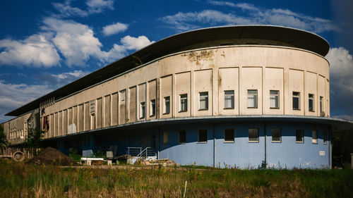 Low angle view of abandoned building against sky