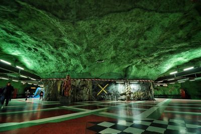 People in illuminated tunnel