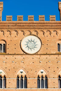 Low angle view of clock tower against clear sky