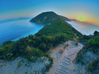 High angle view of sea and mountains against sky