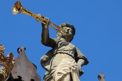 Low angle view of statue against clear blue sky