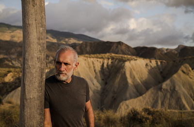 Portrait of man standing on landscape against sky, in tabernas desert, almeria, spain