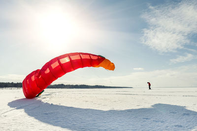 Person paragliding against sky