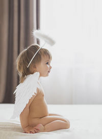 Portrait of cute girl sitting on floor at home