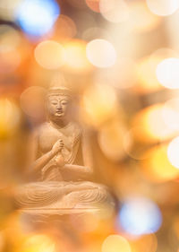 Close-up of illuminated buddha statue