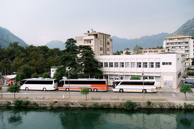 View of city by river against sky