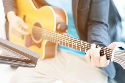 Close-up of man playing guitar