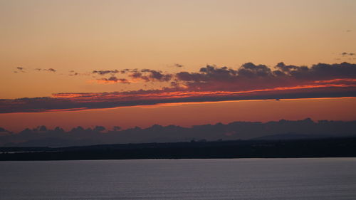 Scenic view of sea against romantic sky at sunset