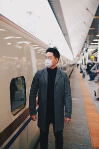 Man standing on railroad station