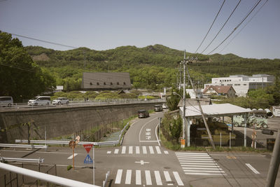 Road by city against sky