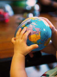 Close-up of hand holding blurred background