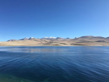 Scenic view of mountains against clear blue sky