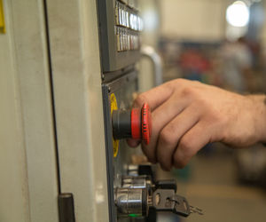 Close-up of man pressing control