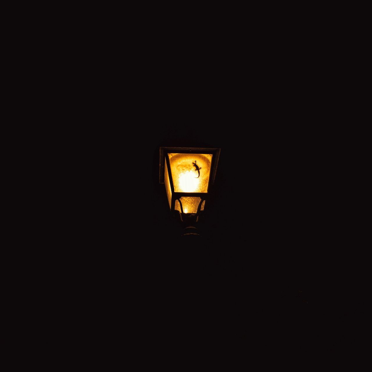 LOW ANGLE VIEW OF ILLUMINATED STREET LIGHT AGAINST DARK SKY