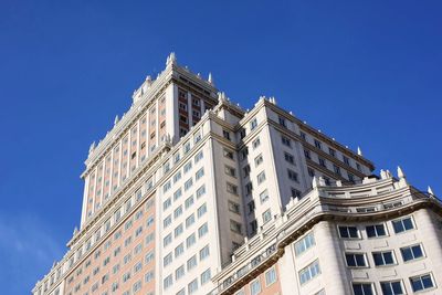 Low angle view of building against clear blue sky