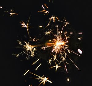 Low angle view of firework display at night