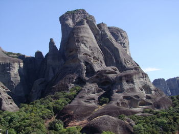 Scenic view of rocky mountains against blue sky