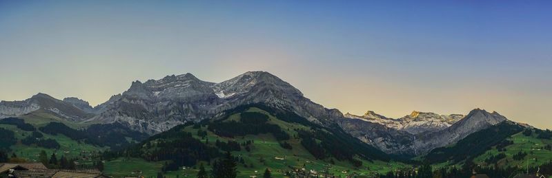 Scenic view of snowcapped mountain against sky during sunset
