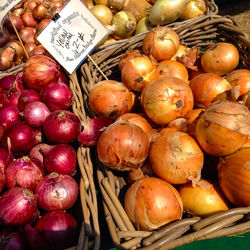 High angle view of onions in wicker baskets for sale at market