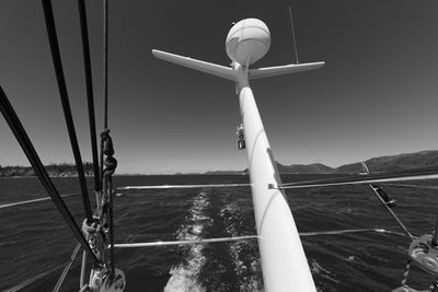 Sailboat sailing on sea against clear sky