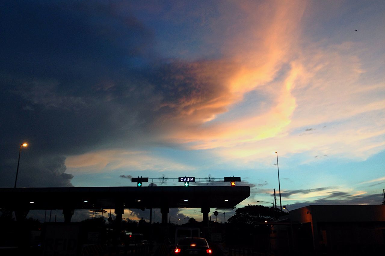 sky, illuminated, sunset, cloud - sky, street light, built structure, building exterior, architecture, transportation, dusk, silhouette, cloudy, lighting equipment, low angle view, city, night, outdoors, cloud, car, communication