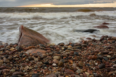 View of rocks at beach during sunset